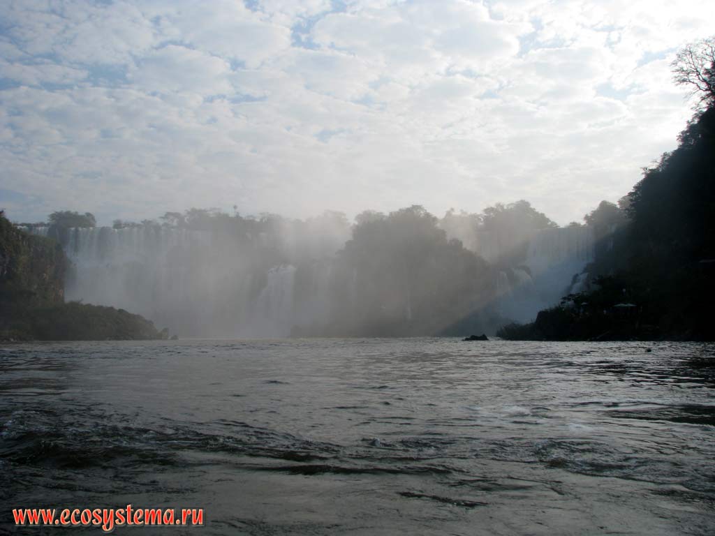 The Iguazu Falls - one of the largest cascade-type waterfalls in the world.
The Iguazu river falling from the edge of the Brazilian plateau. The border between Argentina and Brazil